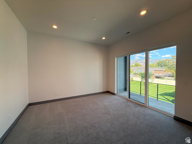8087 South 615 East, Unit 3 Sandy, UT 84070 - Photo 21 of 23 Spacious room featuring neutral carpeting and white painted walls