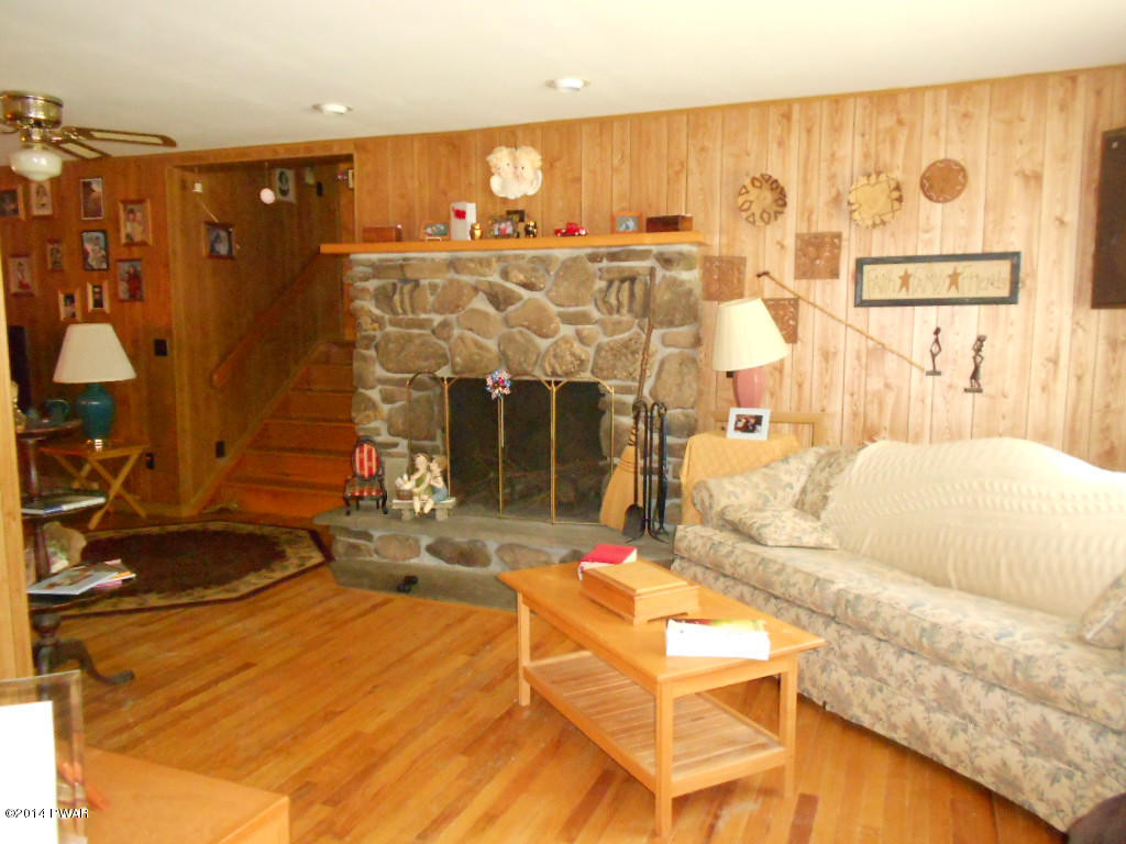 85 Elk Brook Road Road Delhi, NY 13753 - Photo 5 of 11 a living room with furniture and a fireplace