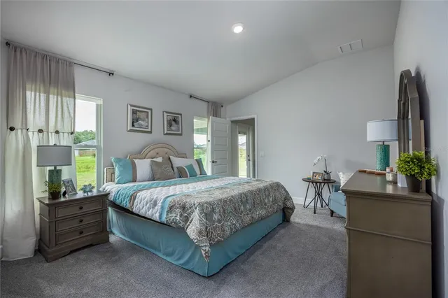 a bedroom with a bed and window