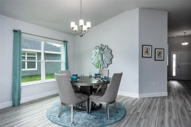 a view of a dining room with furniture and window