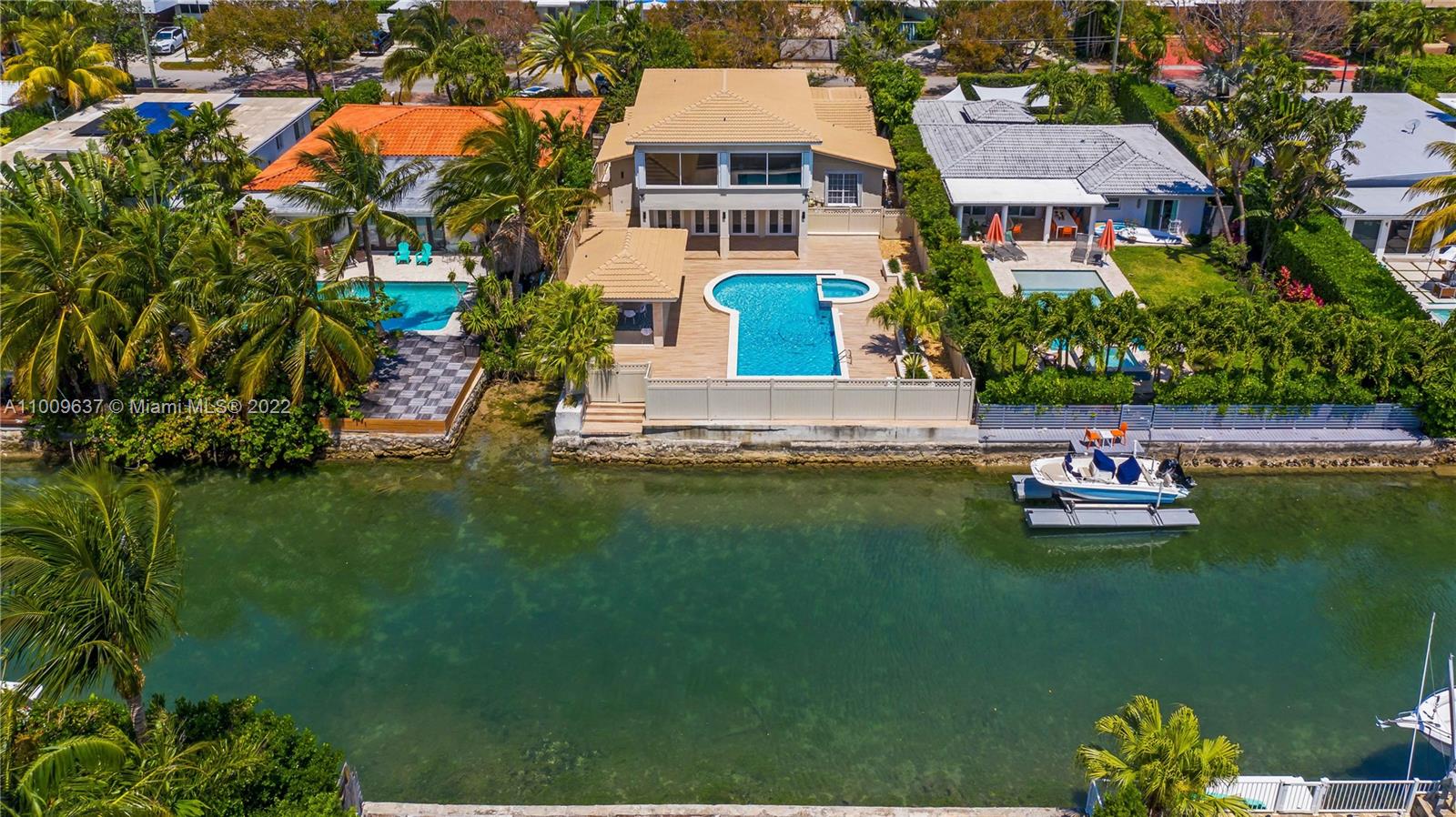 an aerial view of a house with a garden and lake view