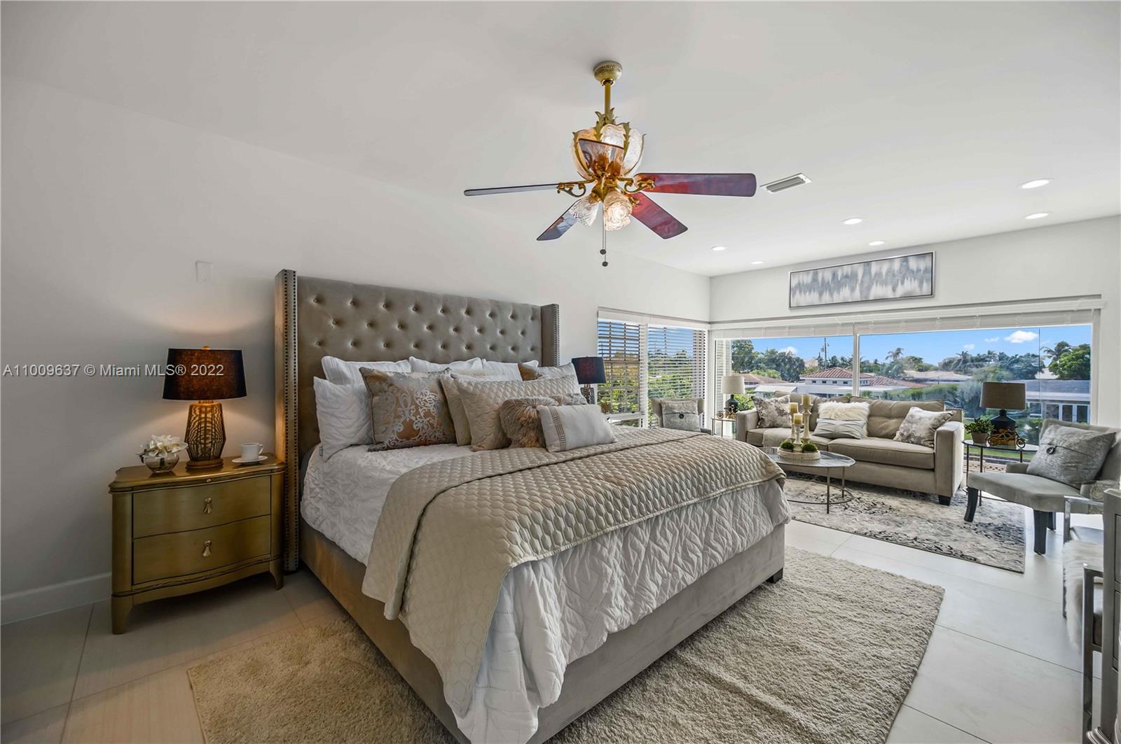 1700 Cleveland Road Miami Beach, FL 33141 - Photo 34 of 60 a bedroom with a bed a couch and a chandelier