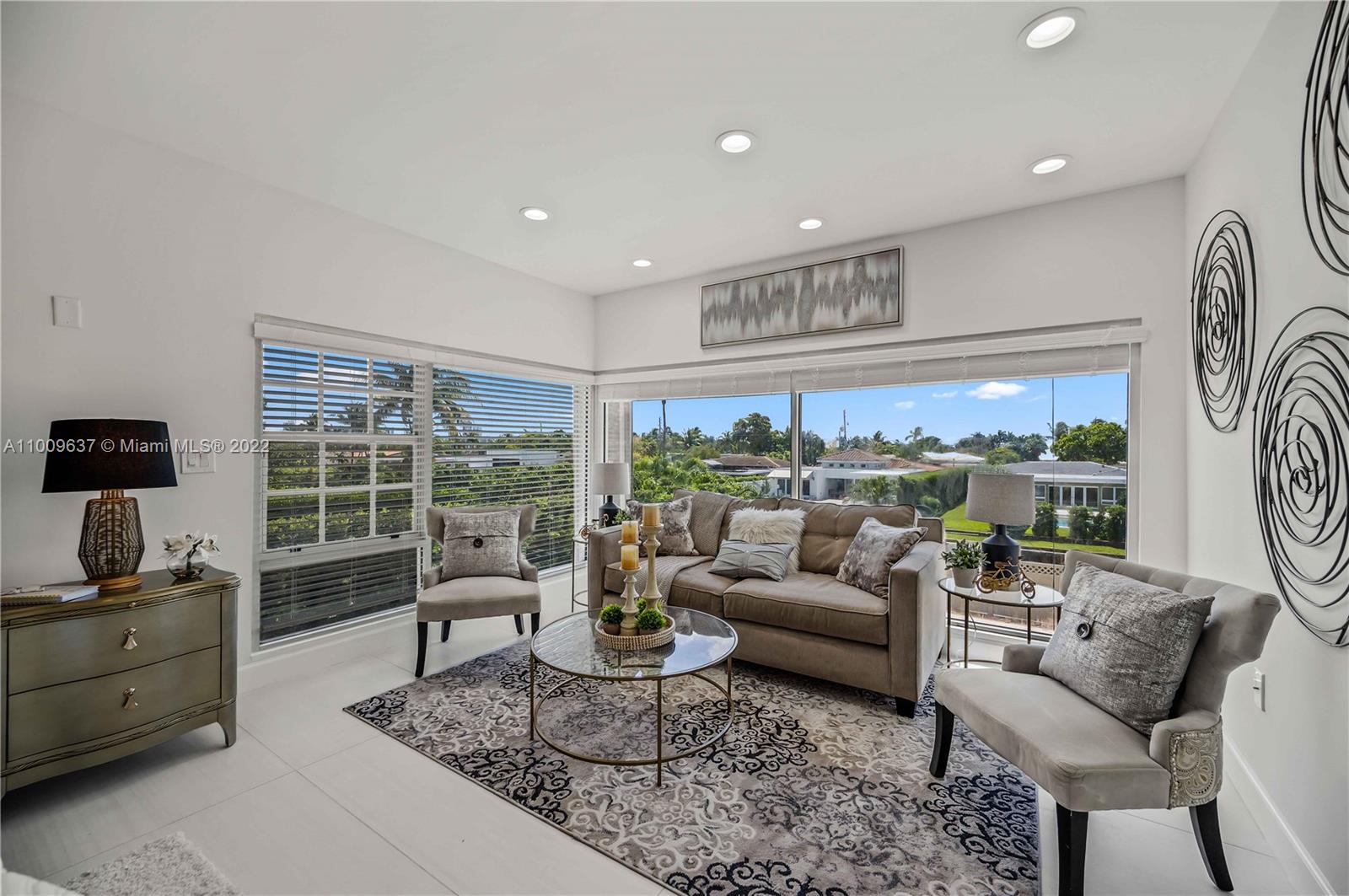 1700 Cleveland Road Miami Beach, FL 33141 - Photo 35 of 60 a living room with furniture tv and a large window
