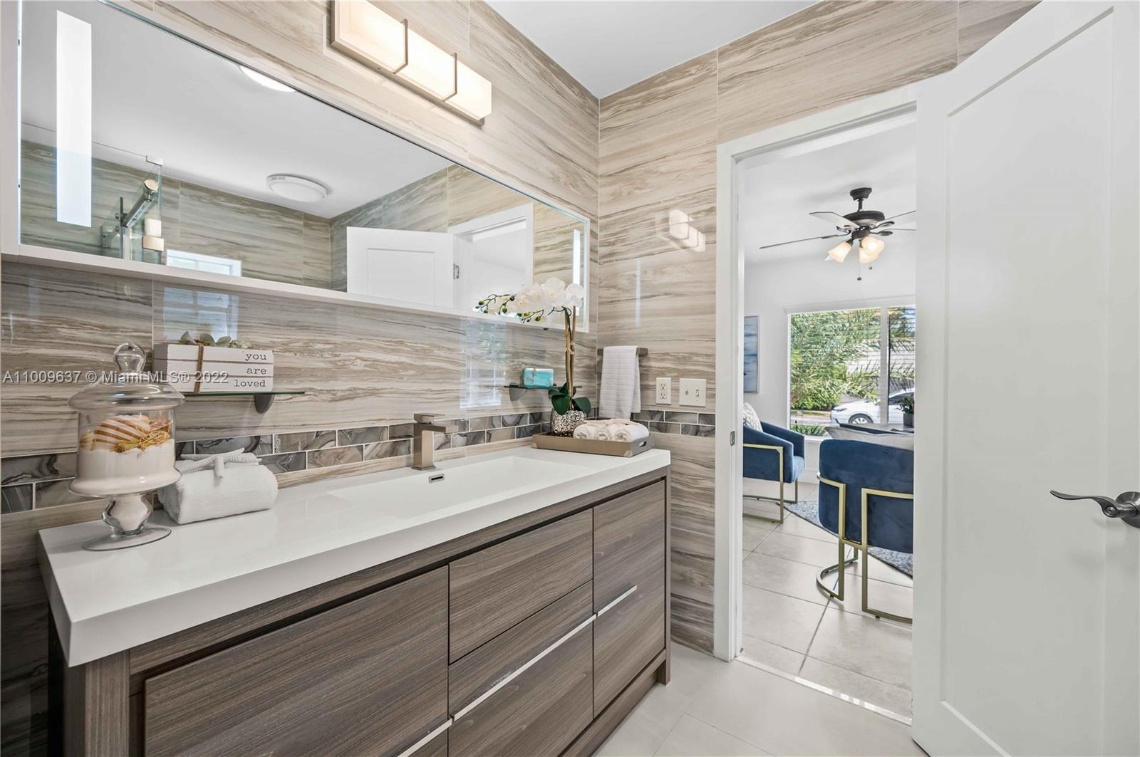 1700 Cleveland Road Miami Beach, FL 33141 - Photo 46 of 60 a bathroom with a sink double vanity and a mirror