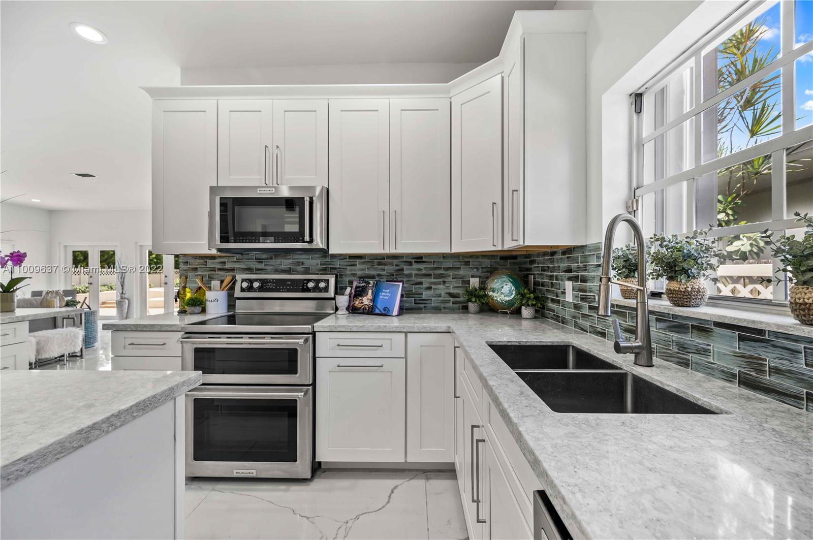 1700 Cleveland Road Miami Beach, FL 33141 - Photo 9 of 60 a kitchen with granite countertop a sink stove and oven