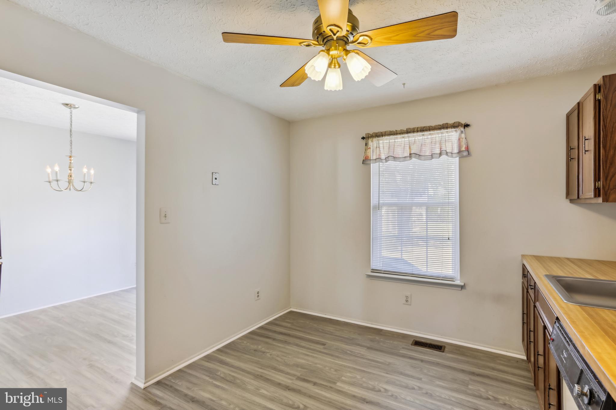 8225 Grainfield Road Severn, MD 21144 - Photo 8 of 35 an empty room with windows and fan