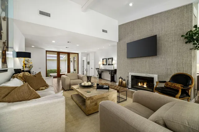 a living room with furniture fireplace and a flat screen tv