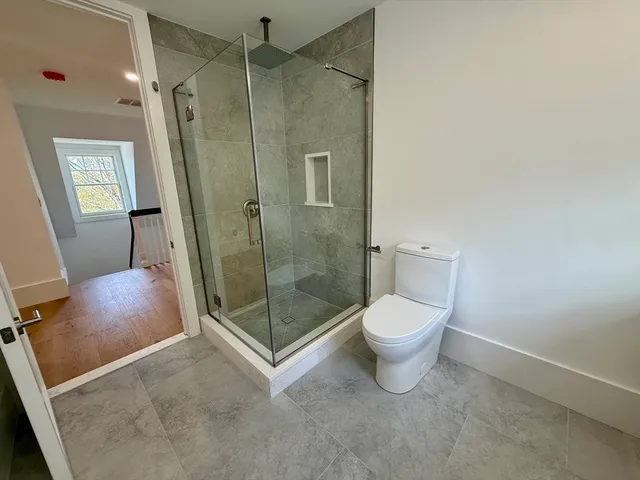a bathroom with a toilet sink and window