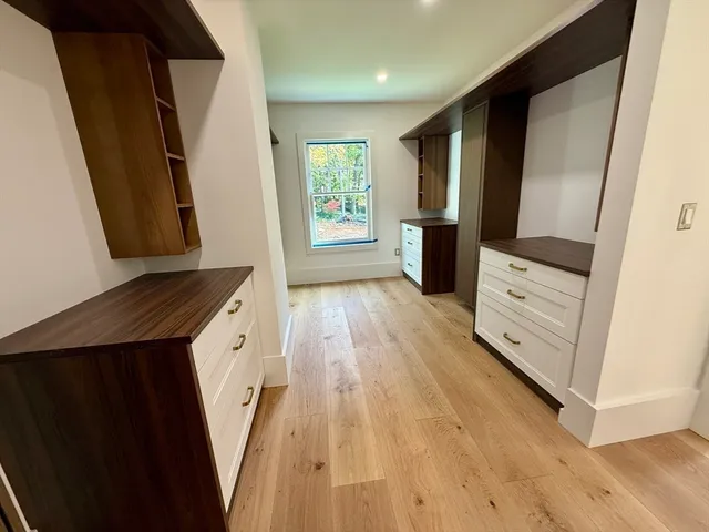 a view of a kitchen with wooden floor and staircase