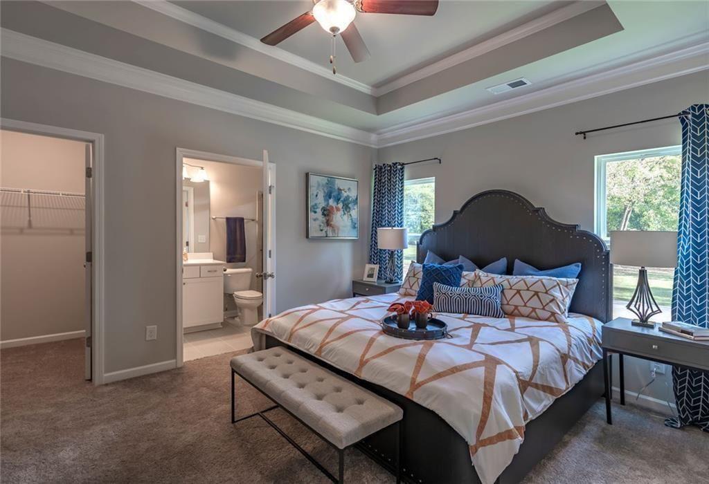 157 Red Oak Lane Calhoun, GA 30701 - Photo 12 of 18 a bedroom with a bed and a chandelier