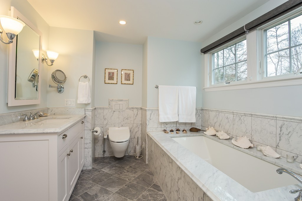 10 Holly Road Marion, MA 02738 - Photo 12 of 29 a spacious bathroom with a double vanity sink a mirror and a bathtub