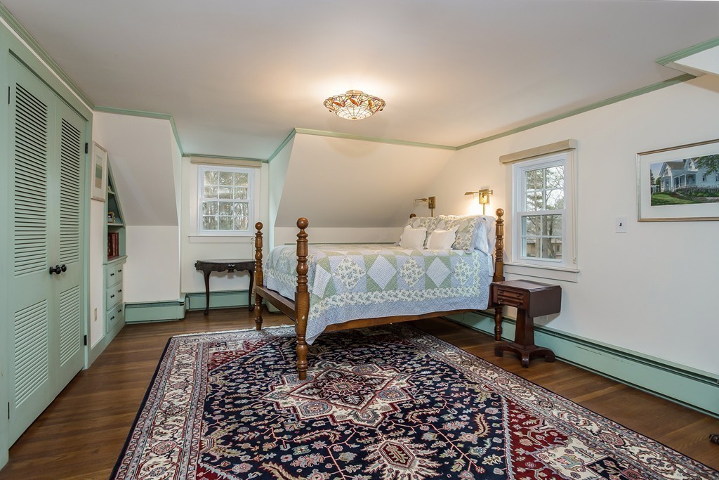 10 Holly Road Marion, MA 02738 - Photo 15 of 29 a bedroom with a bed and a table in it
