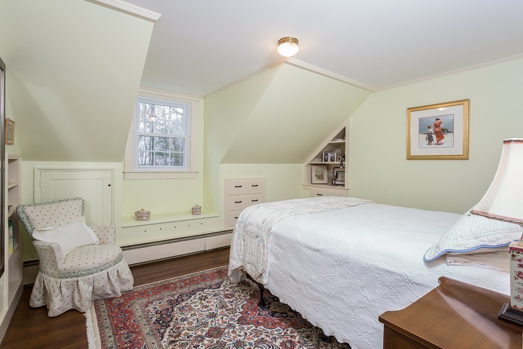 10 Holly Road Marion, MA 02738 - Photo 16 of 29 a bedroom with a bed and wooden floor