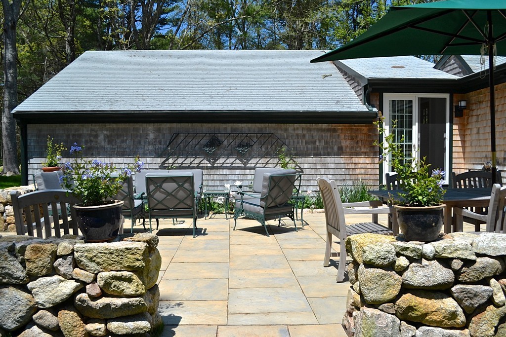 10 Holly Road Marion, MA 02738 - Photo 22 of 29 a view of a patio with table and chairs potted plants
