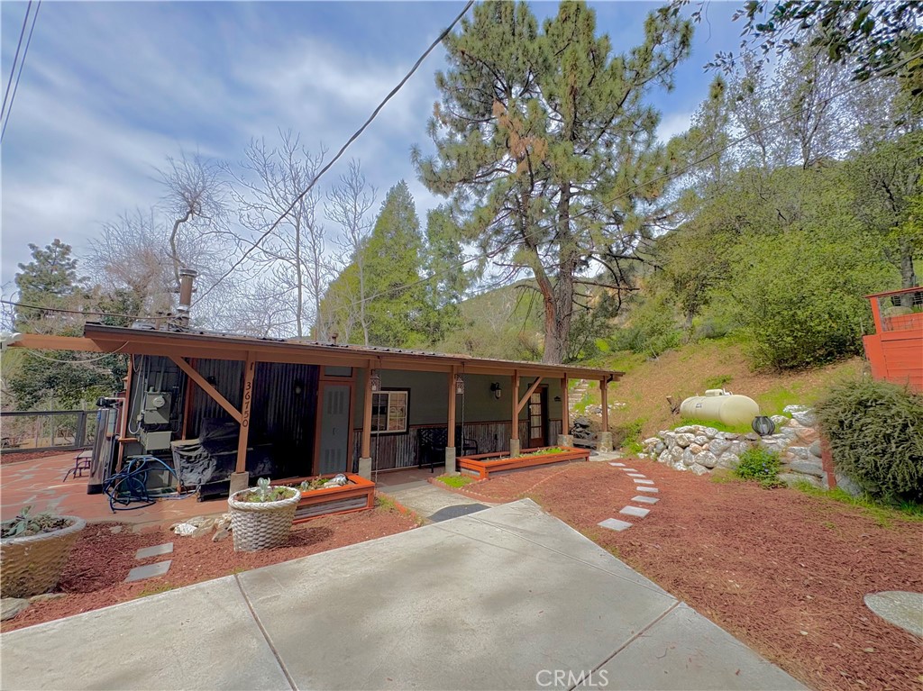 36750 Hilltop Road Yucaipa, CA 92399 - Photo 7 of 27 a view of a house with backyard porch and sitting area