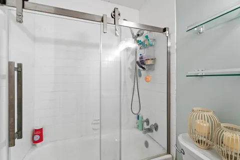 a bathroom with a bathtub and shower