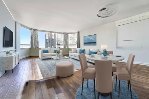 a living room with fireplace furniture and a flat screen tv