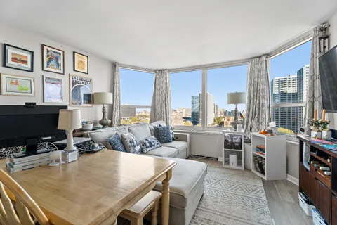 a view of a dining room with furniture and a window