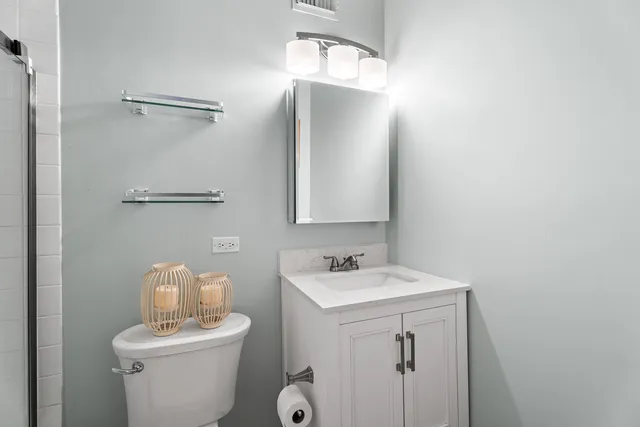 a bathroom with a toilet sink and mirror