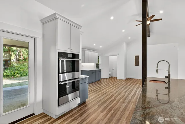 a kitchen with stainless steel appliances granite countertop a refrigerator and a sink