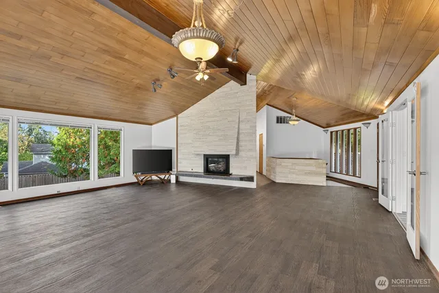 a view of empty room with wooden floor and fireplace