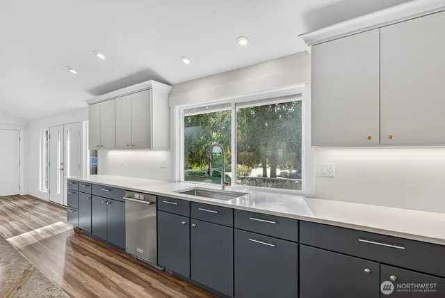 a kitchen with a sink and large window