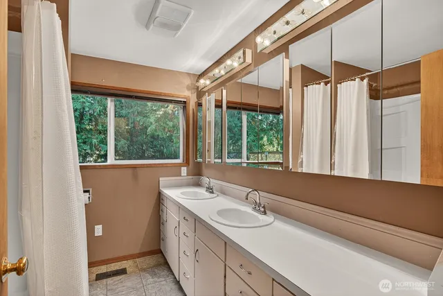 a bathroom with a sink and a large window