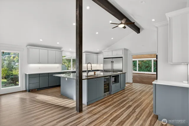 a kitchen with stainless steel appliances a refrigerator sink and stove