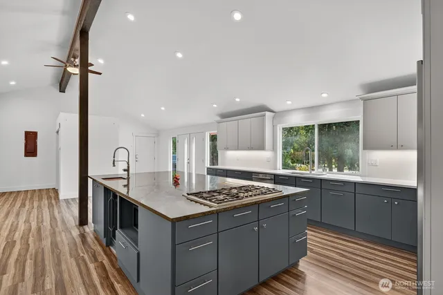 a kitchen with a sink stove and cabinets