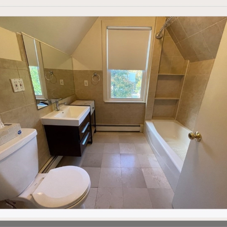 92 Thurston Street, Unit 3 Somerville, MA 02145 - Photo 9 of 10 a bathroom with a sink a toilet and shower
