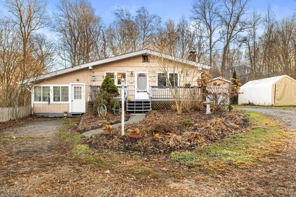a backyard of a house with table and chairs