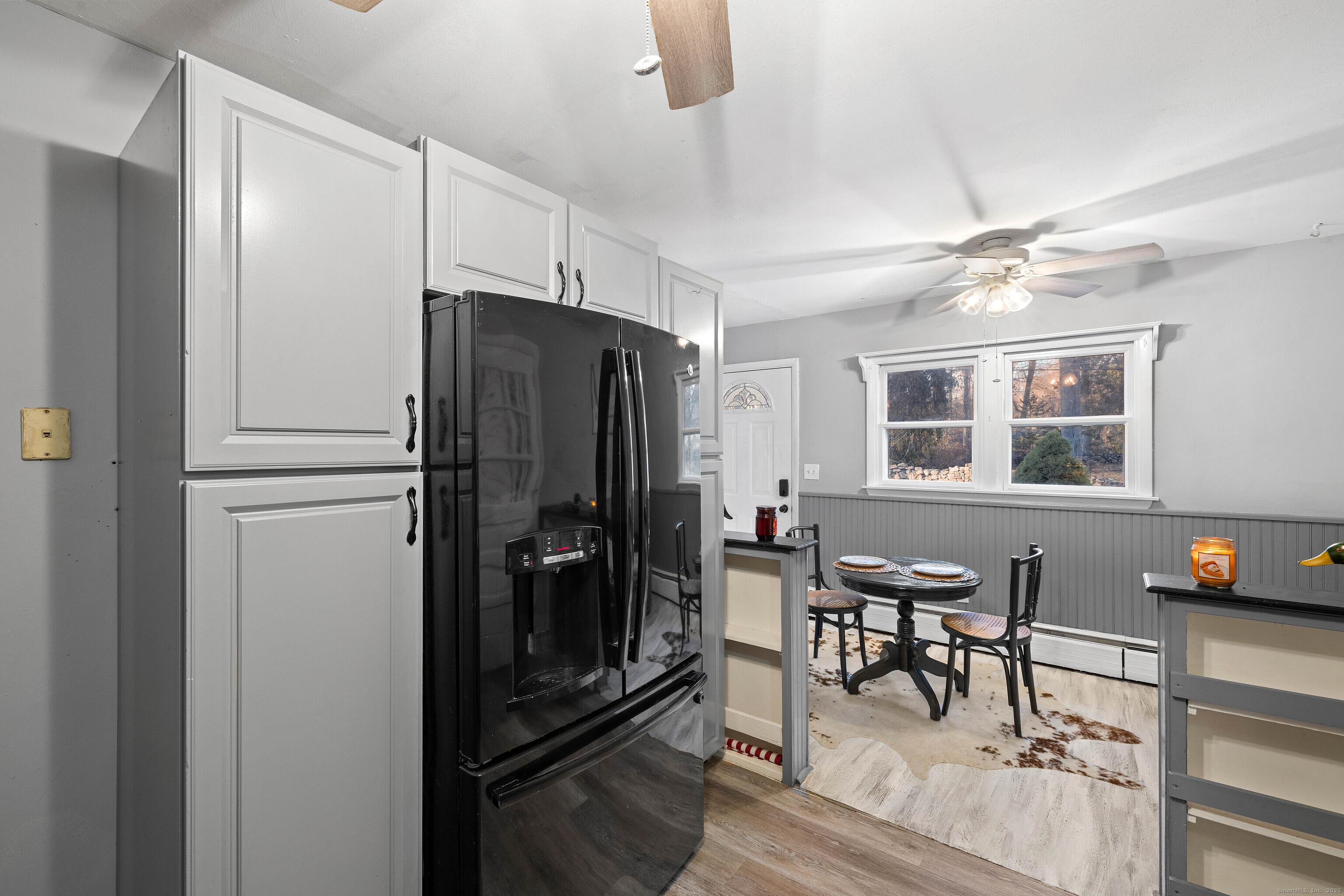 15 Egypt Lane Clinton, CT 06413 - Photo 13 of 40 a kitchen with stainless steel appliances granite countertop a refrigerator a stove a dining table and chairs with wooden floor