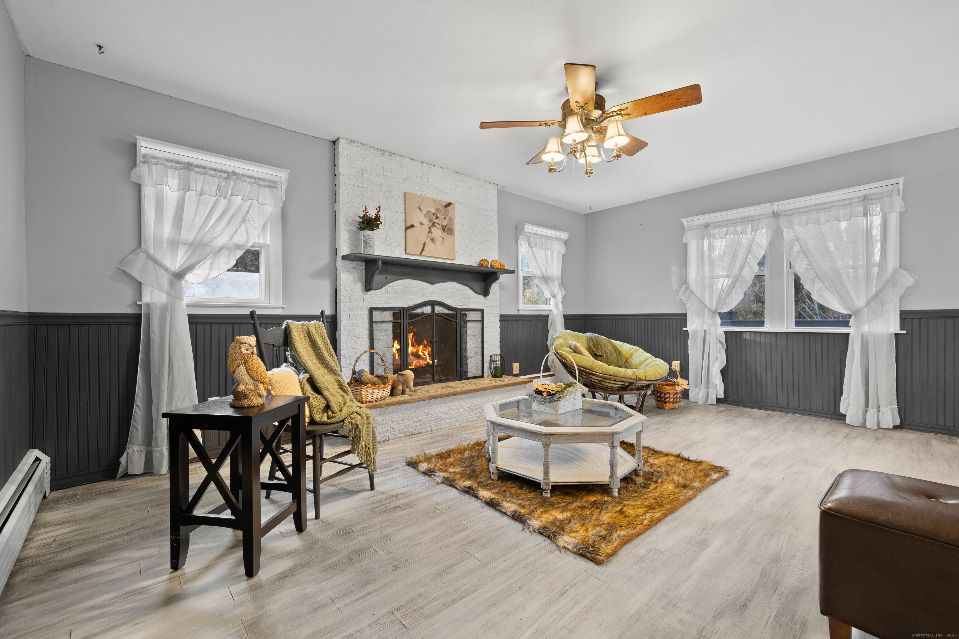 15 Egypt Lane Clinton, CT 06413 - Photo 14 of 40 a living room with furniture a fireplace and a chandelier