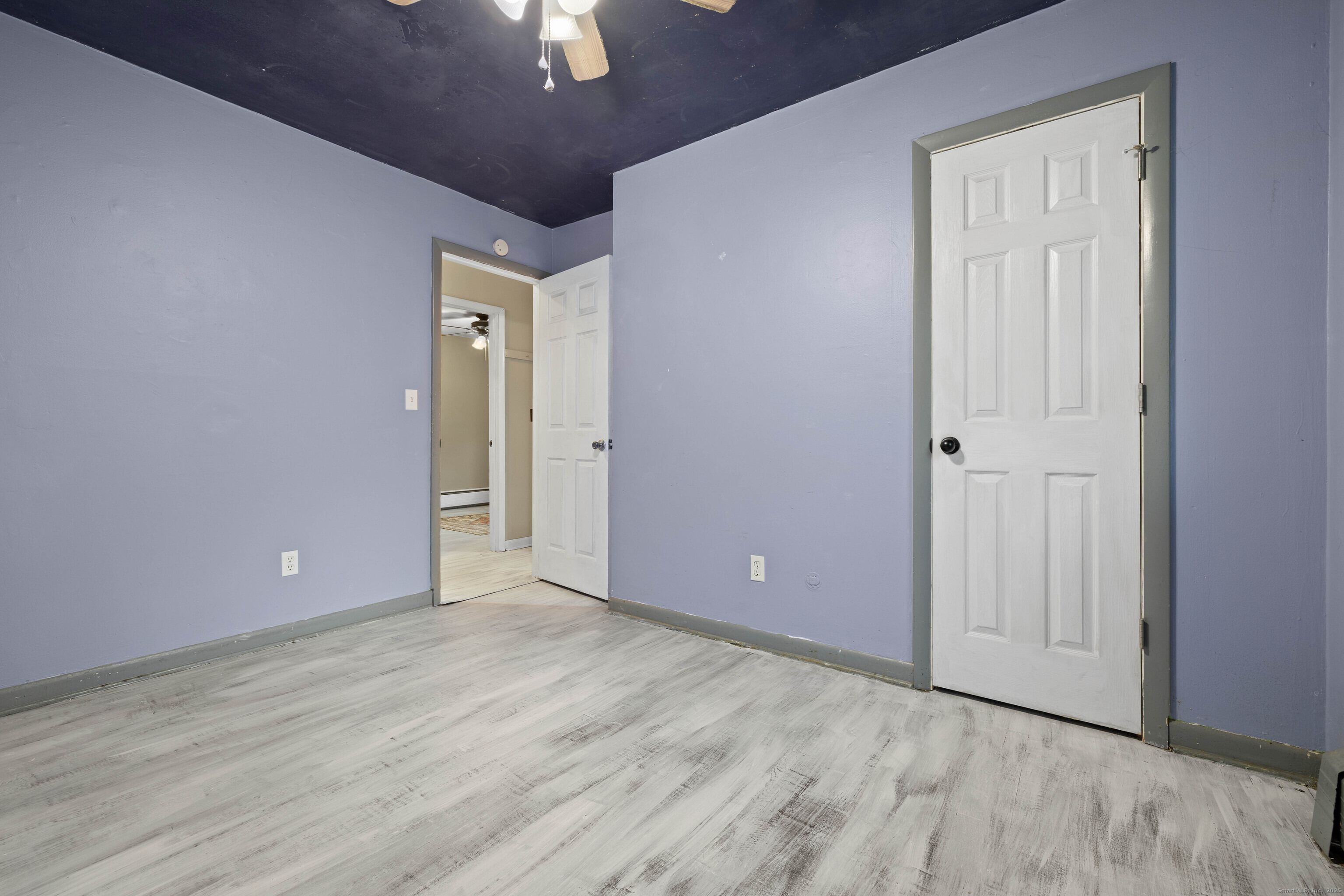 15 Egypt Lane Clinton, CT 06413 - Photo 23 of 40 an empty room with wooden floor and way to kitchen