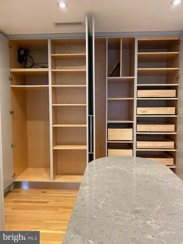 a view of an empty room with empty shelves