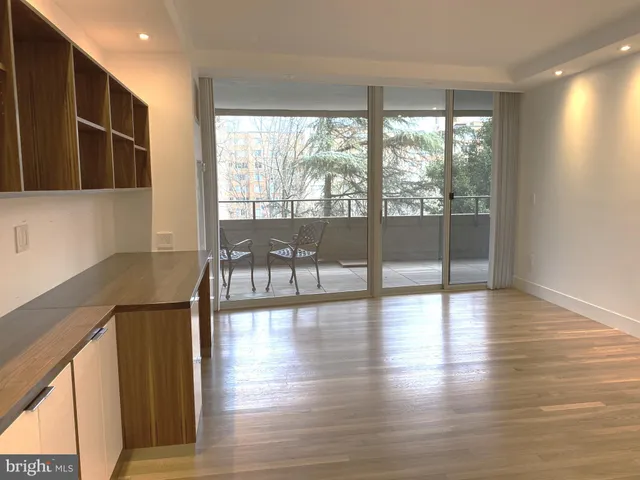 a view of a room with wooden floor and furniture