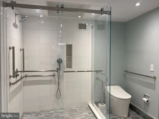 a bathroom with a toilet and a shower