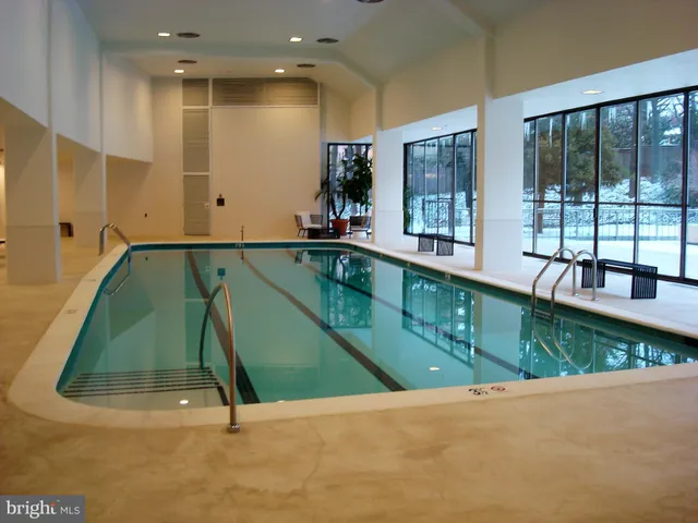 a swimming pool with outdoor seating and yard