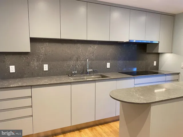 a kitchen with a sink and cabinets