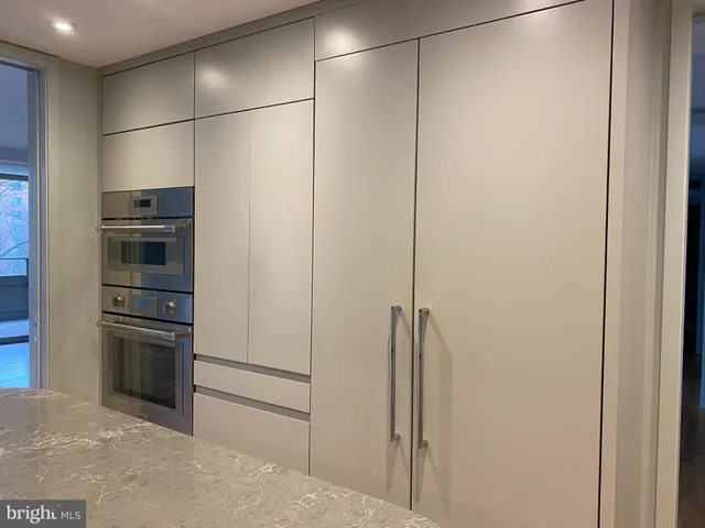 a kitchen with cabinets and stainless steel appliances