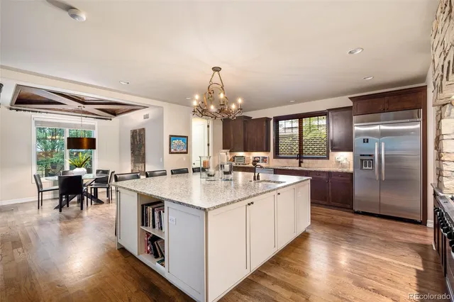 a large kitchen with kitchen island a sink stainless steel appliances and cabinets