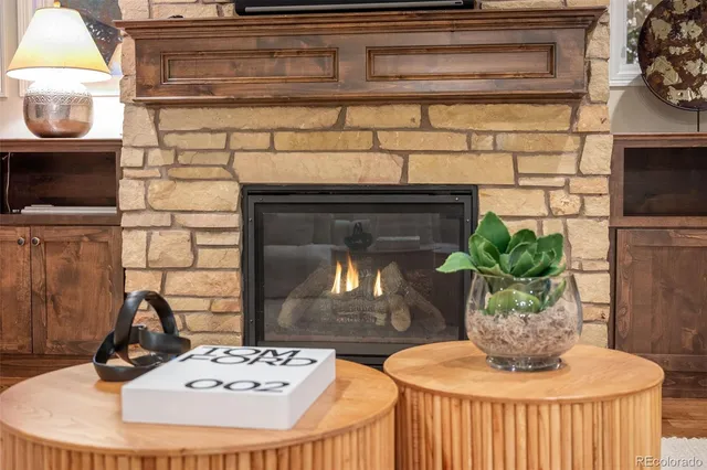 a table with a fireplace and a potted plant