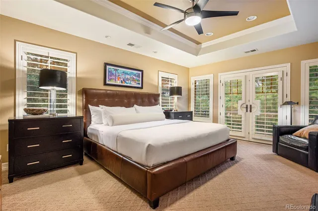 a bedroom with a bed couch and a large window