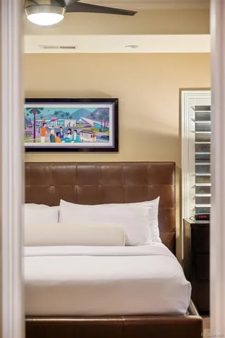 a bedroom with a bed and a chandelier