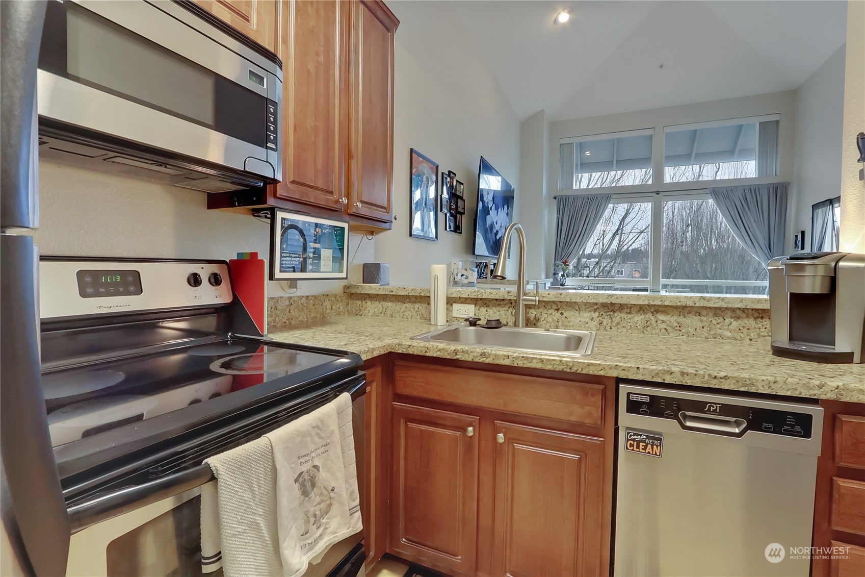 225 Logan Avenue South, Unit 307 Renton, WA 98057 - Photo 15 of 23 a kitchen with stainless steel appliances granite countertop a sink and cabinets