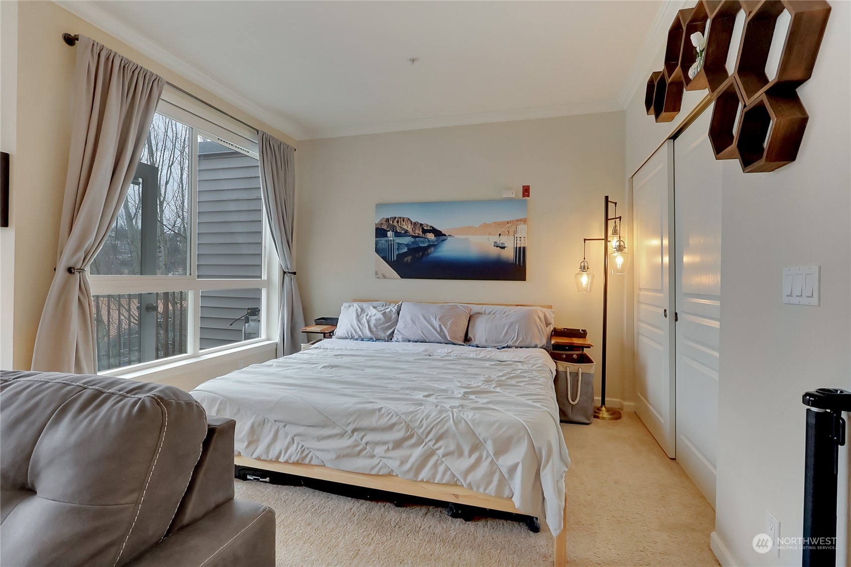 225 Logan Avenue South, Unit 307 Renton, WA 98057 - Photo 19 of 23 a bedroom with a bed and dresser with mirror