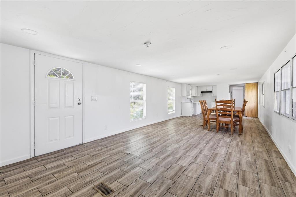 316 Summit Drive Springtown, TX 76082 - Photo 6 of 39 The interior features wood-look tile flooring, white walls, and a white front door with an arched window