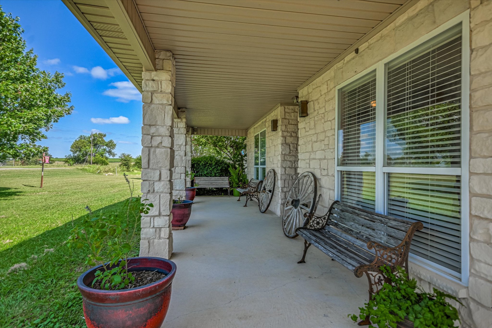 Generous covered front porch offering unobstructed views of the surrounding farmland