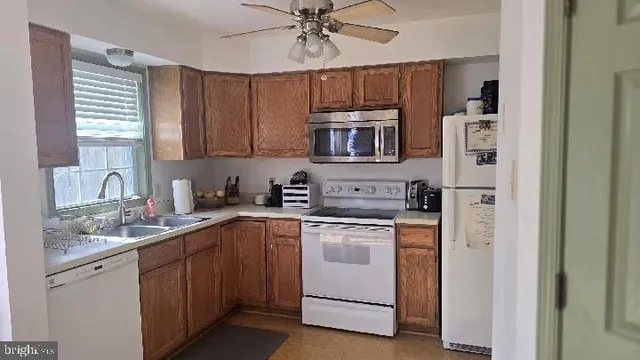 a kitchen with cabinets stainless steel appliances and a counter top space