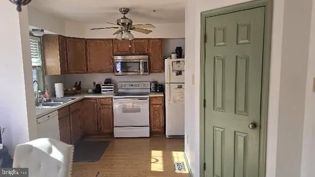 a black leather couch sitting in a room next to a window